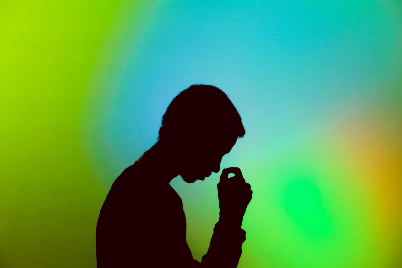 stressed person holding head